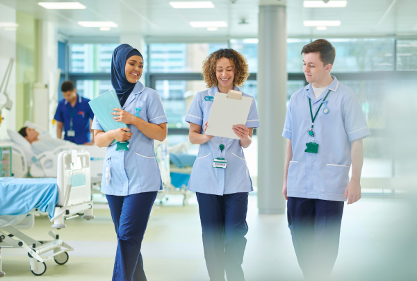 Three nurses walking down the hospital corridor
