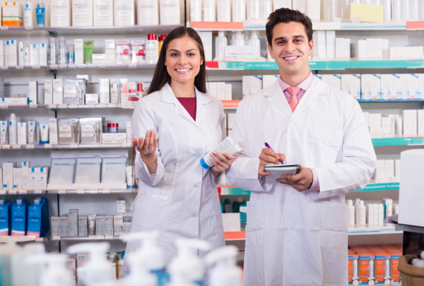 two pharmacists smiling at work