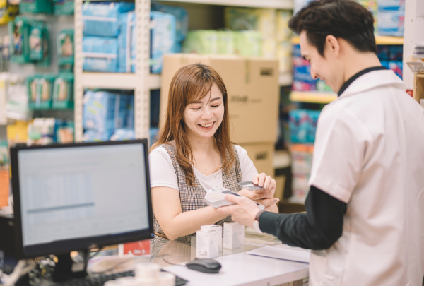 Pharmacy technician with a customer