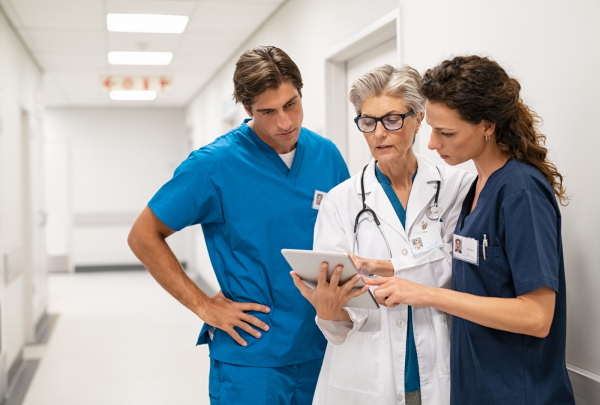 Nurses and doctor looking at iPad